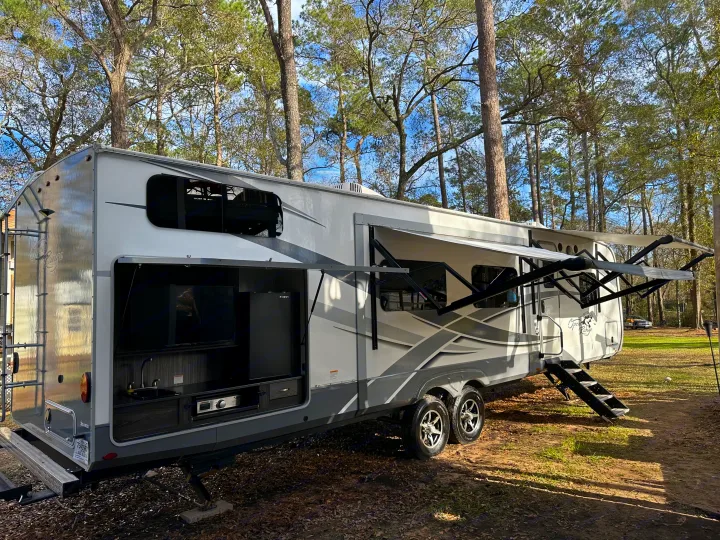 Enjoy the shade of two awnings and the outdoor kitchen with TV!. Highland Ridge RV Open Range 2020