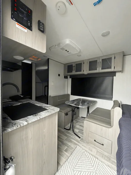 Modern RV rental interior: well-equipped kitchen with dinette, ample storage, and comfortable living space for your adventures.. Dutchmen Kodiak Cub 175BH 2022