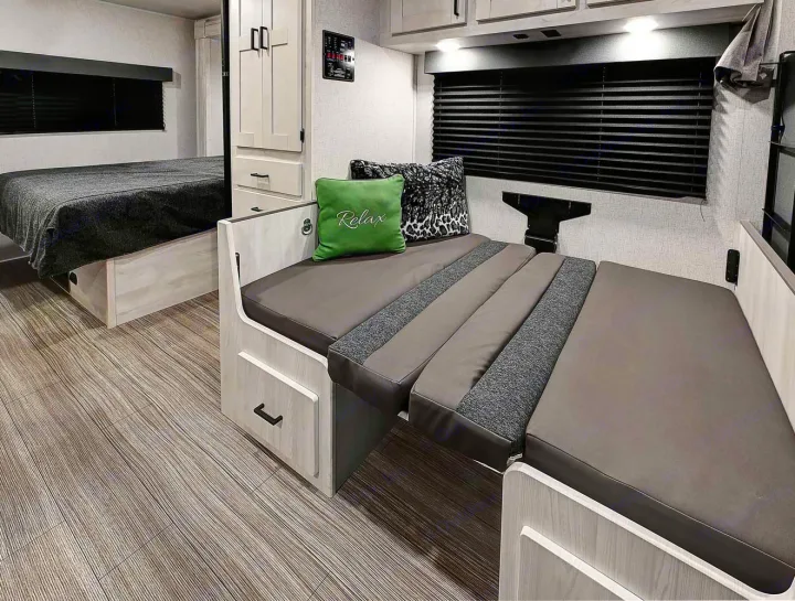 Spacious RV rental interior with a cozy bed, convertible dinette, and ample storage for comfortable adventures.. Forest River Entrada 2022