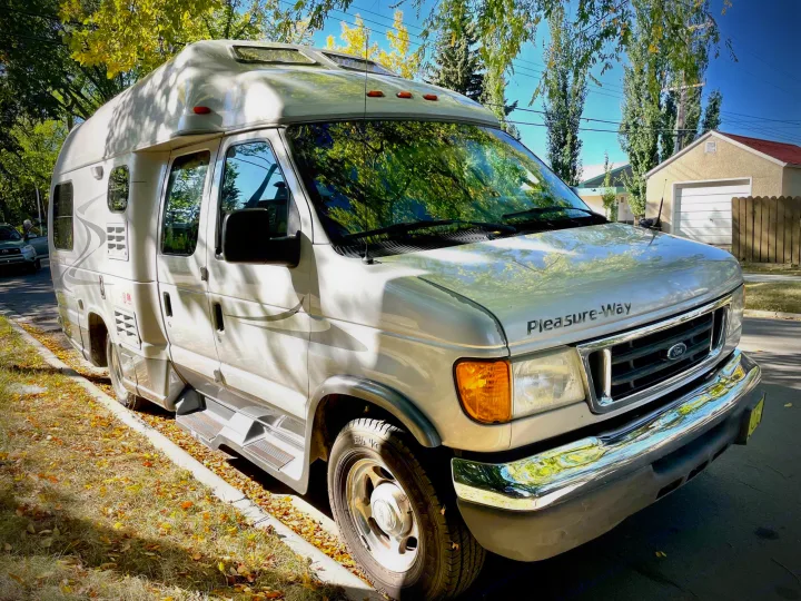 This Pleasure-Way camper van, parked on a sunny street with fall leaves, is perfect for your next RV rental!. Pleasure Way Excel 2007