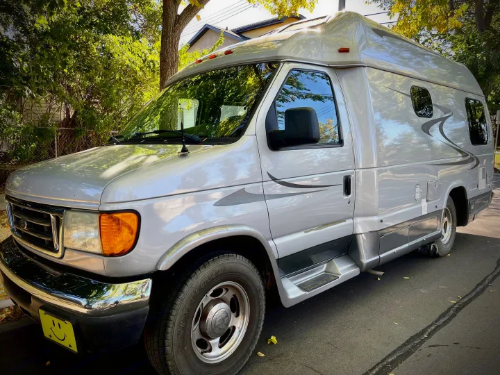 This silver Ford Class B RV rental features a raised roof & custom graphics, ready for adventure.. Pleasure Way Excel 2007