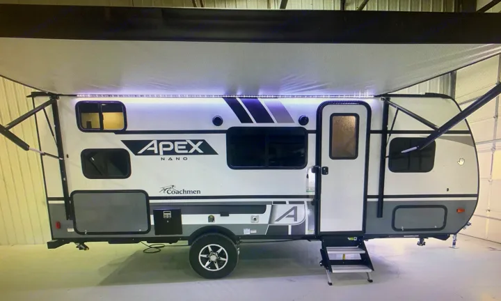 This Apex Nano travel trailer, ready for your next RV rental adventure, features an extended awning with bright LED lights.. Coachmen Apex Nano 2021