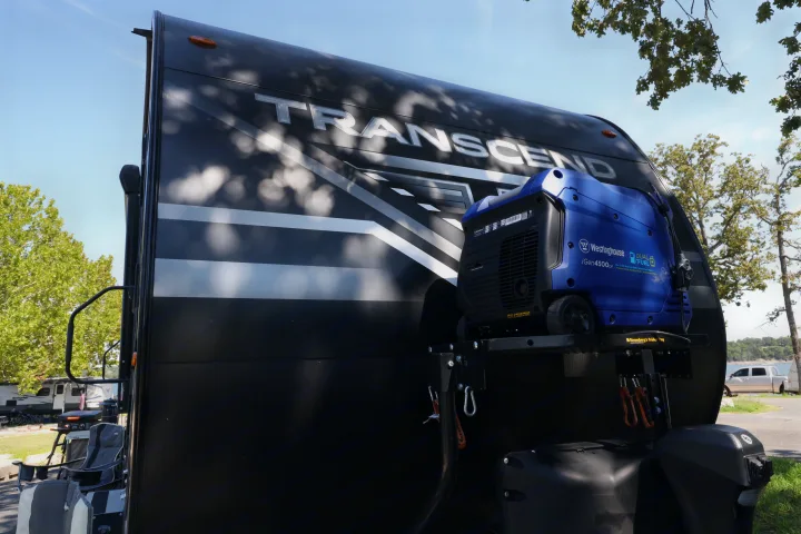 This RV rental showcases a Westinghouse iGen4500DF generator mounted on its front, ideal for off-grid camping.. Grand Design Transcend Xplor 2022