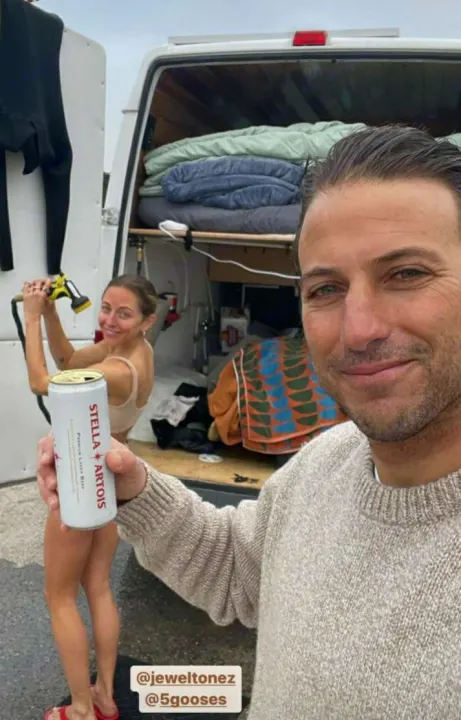 Couple enjoys outdoor shower & beer by their RV rental van, showcasing van life travel.. Mercedes Sprinter 2006