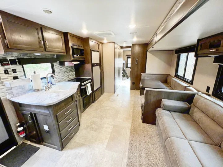 Spacious rv rental interior, featuring a full kitchen, dining area, and comfortable living space. Ideal travel accommodation.. Jayco Jay Flight SLX 2020