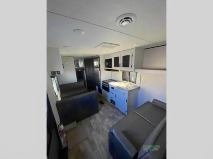 Spacious RV rental interior featuring a modern kitchen, dinette, and living area, ideal for road trips.. Keystone RV Hideout 2022