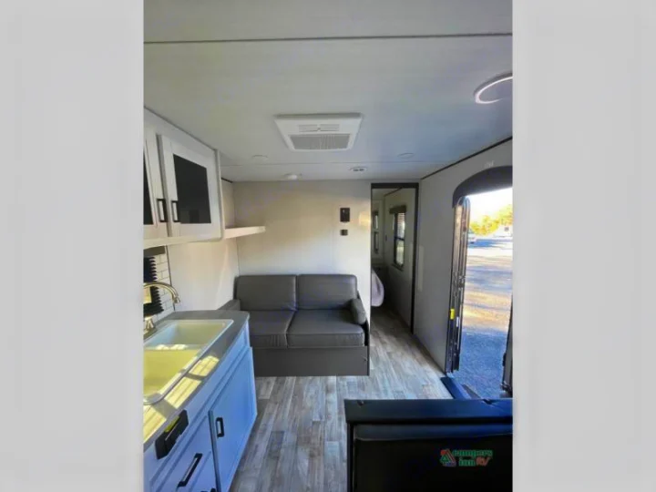 Experience this RV rental's spacious interior with a full kitchen, comfortable living area, and inviting layout. Perfect for travel!. Keystone RV Hideout 2022