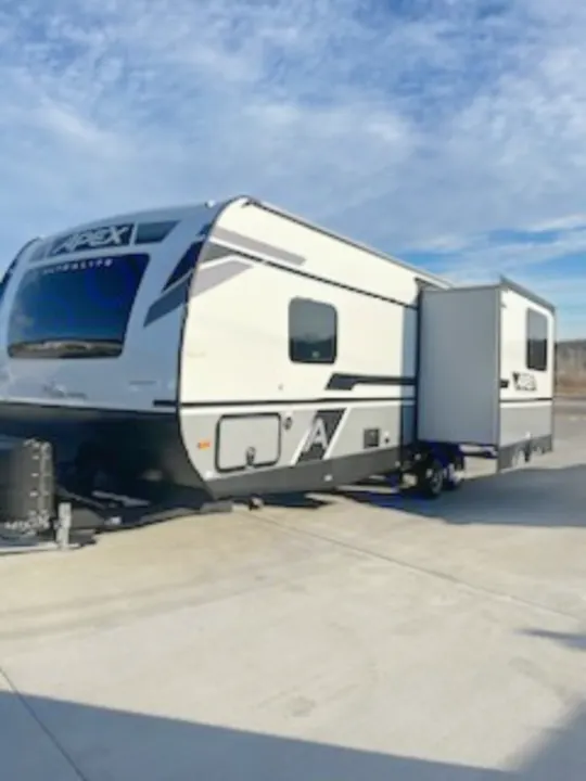 This white & grey Apex travel trailer RV, featuring an extended slide-out, is ready for your next RV rental adventure.. Coachmen 266 BHS 2023
