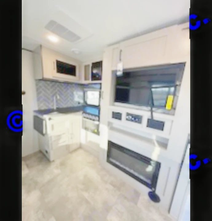 Modern RV rental interior features a compact kitchen and entertainment center with a large TV and fireplace.. Coachmen 266 BHS 2023