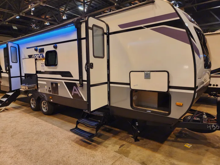 Apex travel trailer, ideal for rv rental, featuring blue LEDs, an outdoor kitchen, and accessible storage compartments.. Coachmen 266 BHS 2023