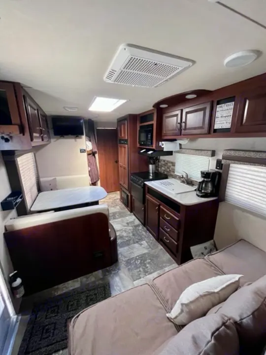 Cozy RV rental interior featuring a complete kitchen, comfortable dinette, and lounge for travel comfort.. Jayco Jay Flight 2015