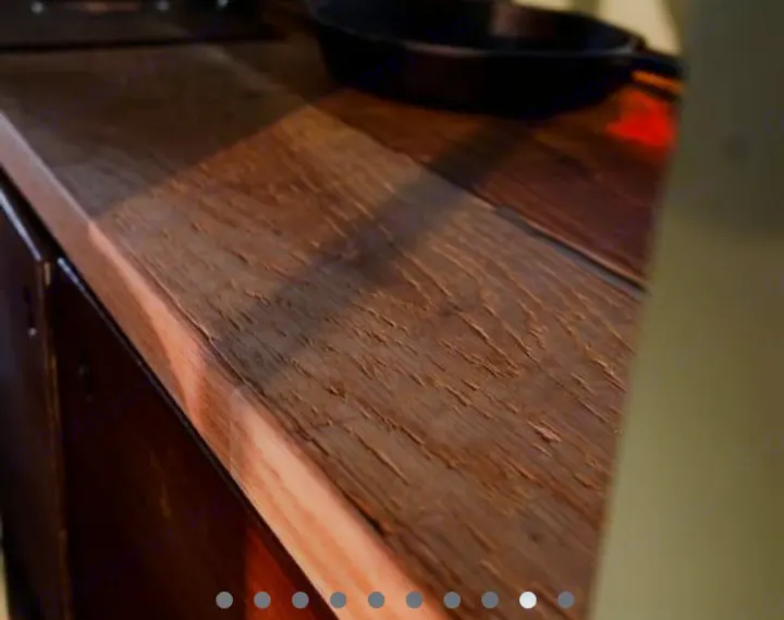 Rustic wooden countertop in an RV rental kitchen, with a cast iron pan & sunbeam. Compact living.. Mercedes Sprinter 2013