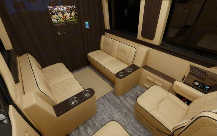 Luxury RV rental interior with plush cream seating, TV, and wood accents for ultimate comfort on the go.. Ultimate Toys Ultimate Cruiser 2022