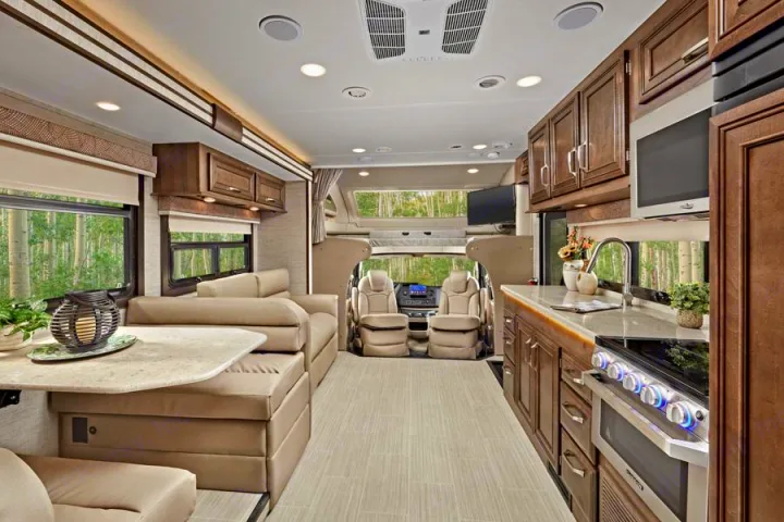 Explore this luxury RV rental interior, featuring a modern kitchen, cozy living space, and front cockpit, perfect for scenic travels.. Entegra Esteem 29v 2022