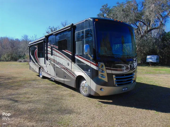 Spacious Class A motorhome parked on a grassy field, ready for your next RV rental adventure.. Thor Challenger 2015