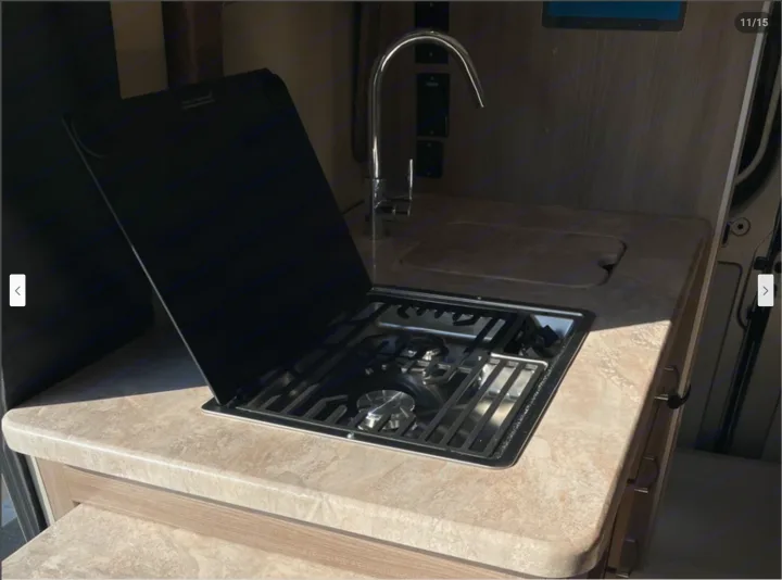RV rental kitchen: A two-burner stove, sink with faucet, and light countertop offer cooking space.. Thor Motor Coach Scope 2022