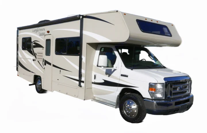 Side view of a beige and white Class C Leprechaun Coachmen rv rental, a motorhome with graphics, perfect for road trips.. Forest River Coachmen Leprechaun 2017