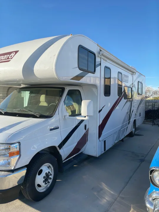 Ready for adventure! A white Coleman Class C E-450 rv rental parked on concrete.. Thor Coleman 2022