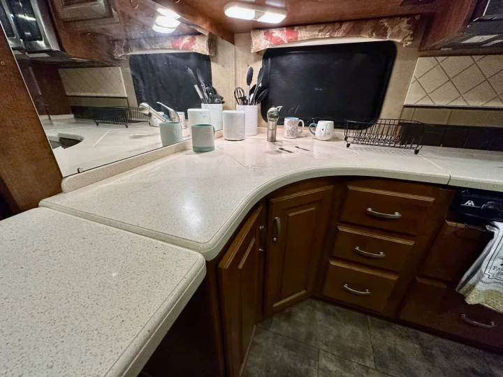 Well-appointed kitchen in an RV rental, featuring light countertops, dark cabinets, and all essentials for comfortable travel.. Thor Challenger 2015