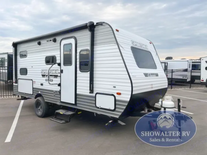 A modern grey & white Sportsmen Classic travel trailer, perfect for your next rv rental adventure, parked at an RV lot.. KZ Sportsmen Classic 191BHK 2025