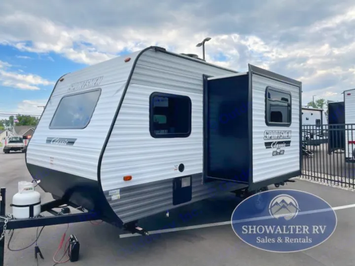 A grey & black Sportsmen Classic travel trailer with an extended slide-out, ready for rv rental. Propane tank visible at front.. KZ Sportsmen Classic 191BHK 2025