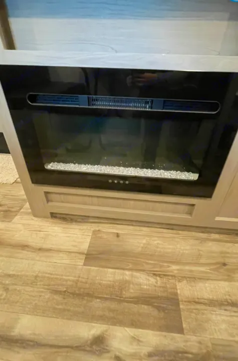 RV rental: Modern electric fireplace with crystal embers in light cabinetry, on wood-look laminate flooring.. Other Other 2021