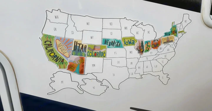 This RV rental features a U.S. map sticker, tracking adventures across states like California, New York, and Ohio.. Thor Four Winds 2022