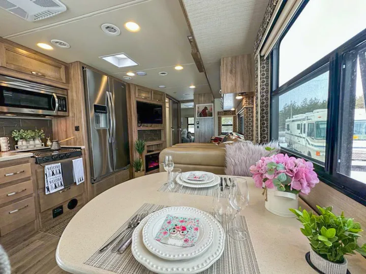 This spacious and modern RV rental interior features a full kitchen, dining area, and cozy living space.. Jayco Precept 2019