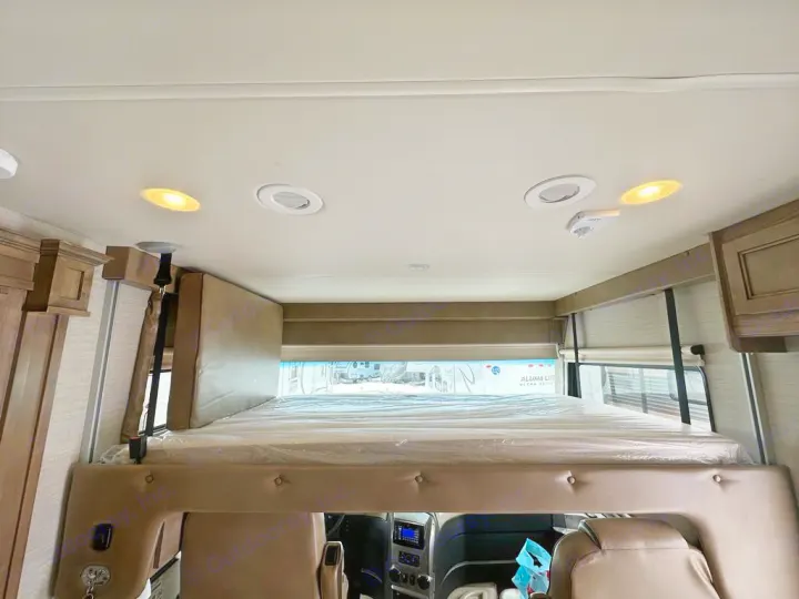 RV rental interior: Front overhead bunk with mattress, recessed ceiling lights, and wood cabinets are visible in this spacious camper.. Jayco Precept 2019