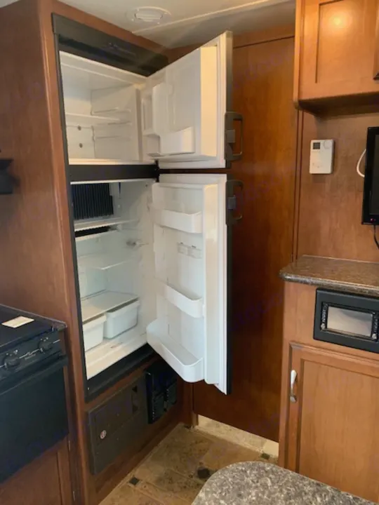 RV rental kitchen: Features dual top-loading refrigerators, a microwave, and stove for a complete cooking setup.. Winnebago Other 2013
