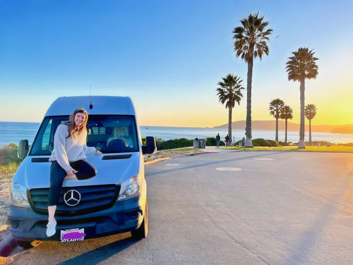 Coastal rv rental adventure! Woman on white van at sunset, overlooking ocean and palm trees.. Mercedes-Benz Sprinter RV Motorhome Campervan 2016