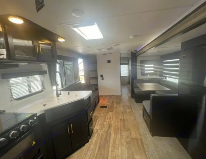 Open floorplan perfect for lounging, socializing, and playing games. Will come with installed Smart TV where mount is shown in photo for movie night! . Forest River Cherokee 2022