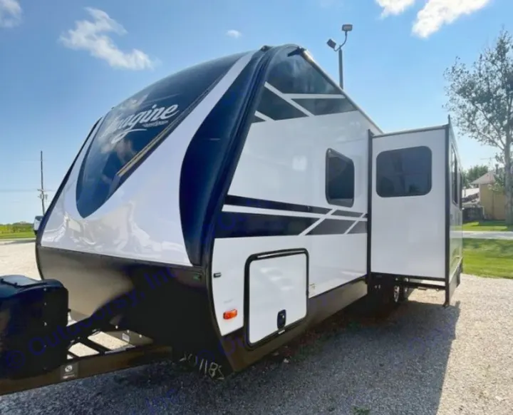 Sleek white and black Imagine travel trailer RV with extended slide-out, perfect for an rv rental adventure.. Grand Design Imagine 2021