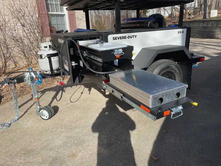 This heavy-duty **RV rental** utility trailer features a pull-out kitchen, propane tank, and storage for outdoor adventures.. Schutt XV-3 Severe Duty 2022