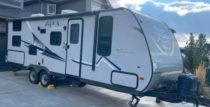 Grey and white Coachmen Apex Ultra-Lite travel trailer, perfect for your next RV rental. Parked on a driveway.. Coachmen Apex LE 2018