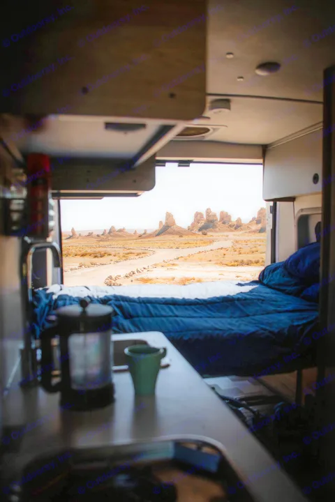 This RV rental offers breathtaking desert views through its back doors, featuring a cozy bed, French press, and morning coffee.. Winnebago Solis 2021