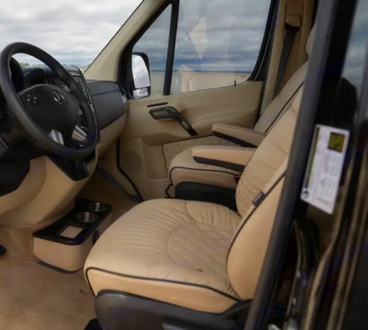 Step into comfort with this RV rental's luxurious Mercedes-Benz van interior, featuring cream leather captain's chairs and custom details.. Midwest Automotive Designs Daycruiser 2019