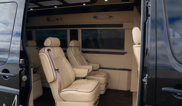 RV rental interior: luxurious & spacious, featuring cream captain's chairs with elegant diamond stitching.. Midwest Automotive Designs Daycruiser 2019