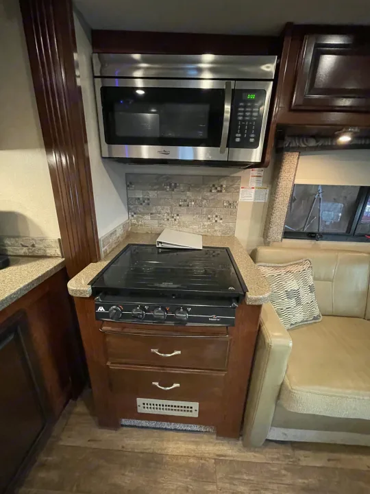This rv rental features a well-equipped kitchen with a stainless steel microwave, gas stove, and ample counter space.. Jamboree Jamboree Motorhome 2017