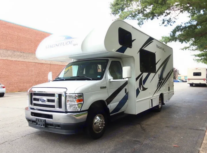 Explore in style! This white Thor Magnitude Class C RV rental on a Ford chassis features striking blue & black graphics.. Thor Magnitude 2021