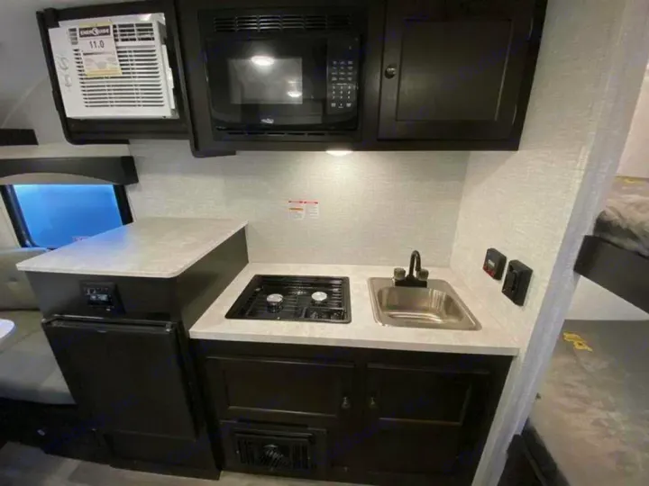 This RV rental features a well-equipped compact kitchen with microwave, fridge, stovetop, & sink for your travels.. Braxton Creek Bushwhacker Plus 2021