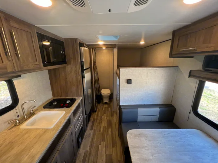 Spacious RV rental interior featuring a full kitchen, dinette, bathroom, and bunk area, all in a modern design.. Crossroads Zinger Lite 2022