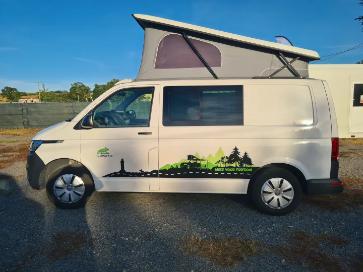 White camper van with pop-top roof and nature graphics, perfect for RV rental adventures.. Volkswagen Transporter T6.1 2021