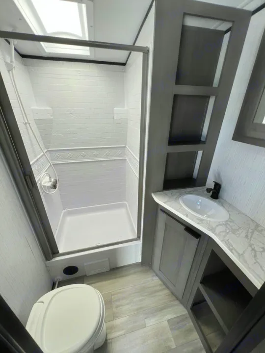 Step inside this modern RV rental bathroom! Features include a compact shower, toilet, and vanity with sink & storage.. Cruiser Rv Corp MPG 2700TH 2022