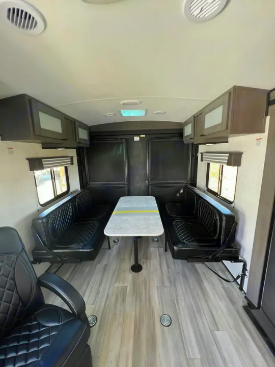 RV rental interior: spacious living area with two bench seats, removable table, and overhead cabinets.. Cruiser Rv Corp MPG 2700TH 2022