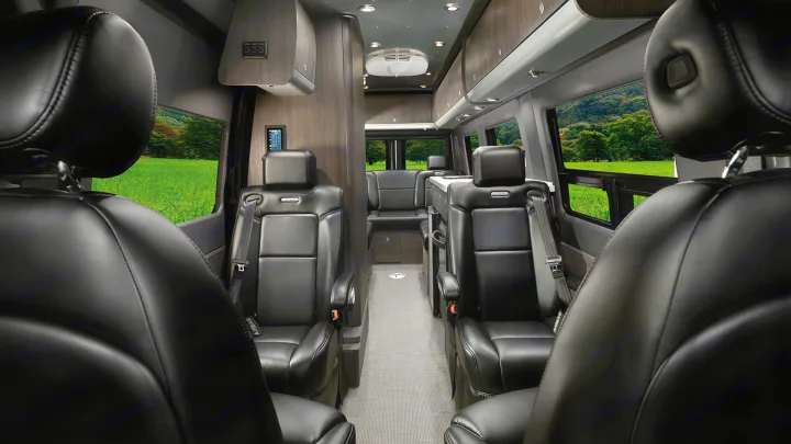 Step inside this modern rv rental, featuring plush black leather seats, ample storage, and wide windows for scenic views.. Airstream Interstate 2021
