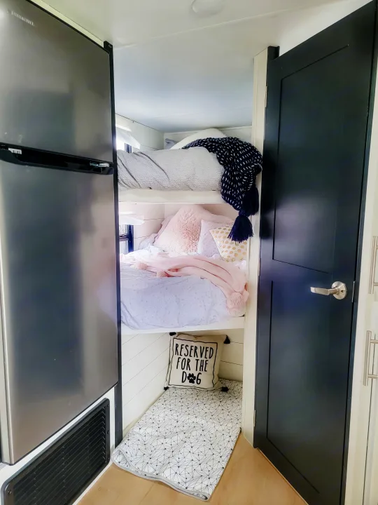 Cozy RV rental features bunk beds, a dedicated dog sleeping area, and a large refrigerator for family adventures.. Forest River Tracer 2022