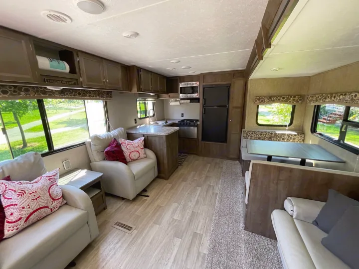 Spacious RV rental interior with kitchen, living area, and dinette, perfect for travel trailer adventures.. Coleman Lantern 28.6 RK 2018