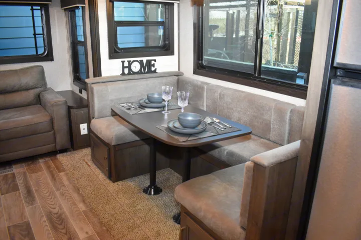 RV rental: Modern RV interior featuring a comfortable dinette, sofa, and kitchen area, ideal for your travels.. Jayco Jay Flight SLX Rocky Mountain Edition 2021
