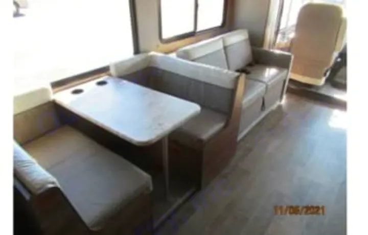 RV rental interior: A compact dinette with table and sofa seating in the cozy living area for travel comfort.. Winnebago Intent 2018